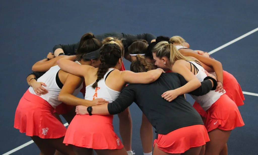 Women's college tennis team before match