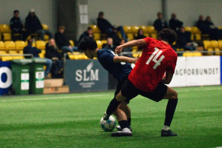 To spillere som kjemper om en ball mens college-trenere ser på Keystone Sports College Soccer Showcase